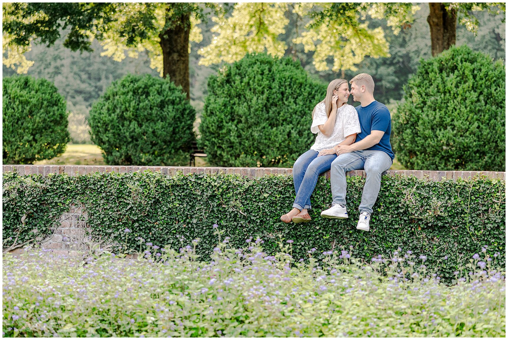 Engaged couple Sarah and Ian sharing a candid moment in the gardens at Morven Park