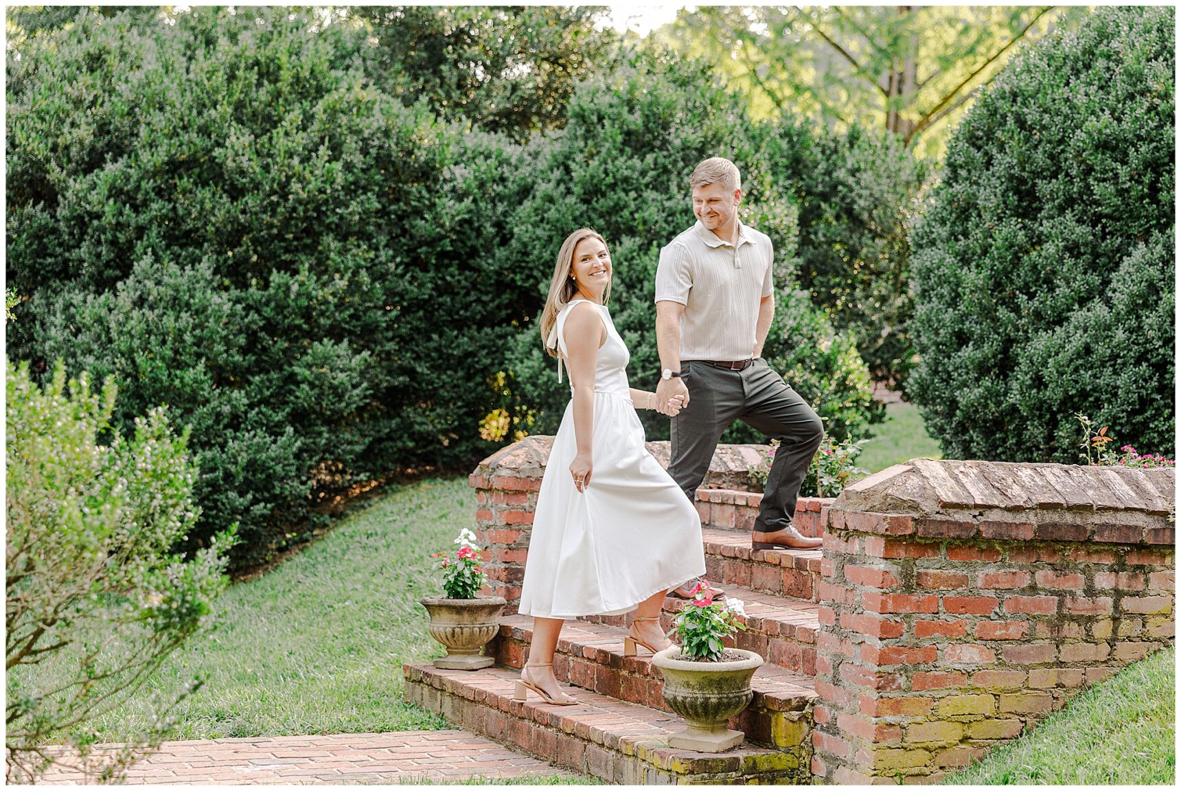 Couple exploring the gardens together during a summer engagement session at Morven Park