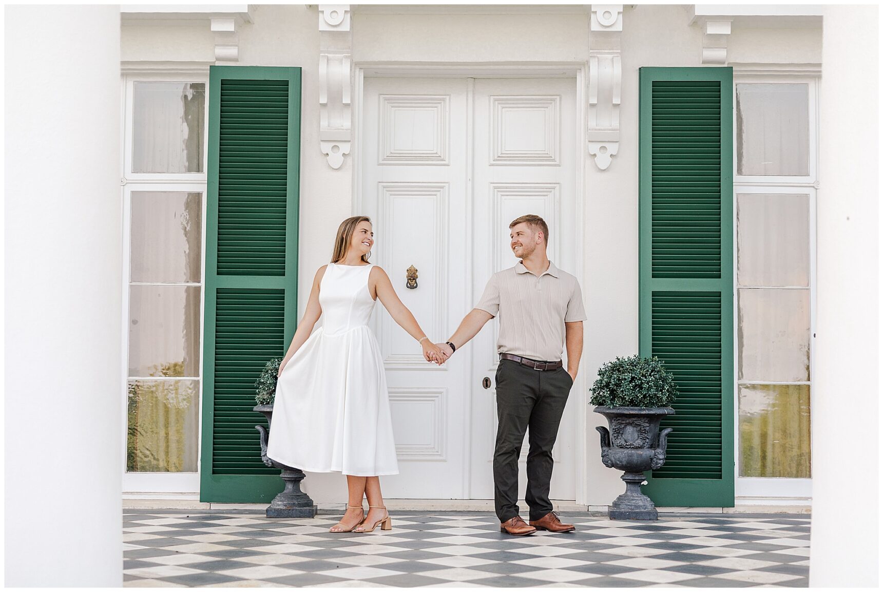 Sarah and Ian walking hand in hand through the gardens at Morven Park during golden hour