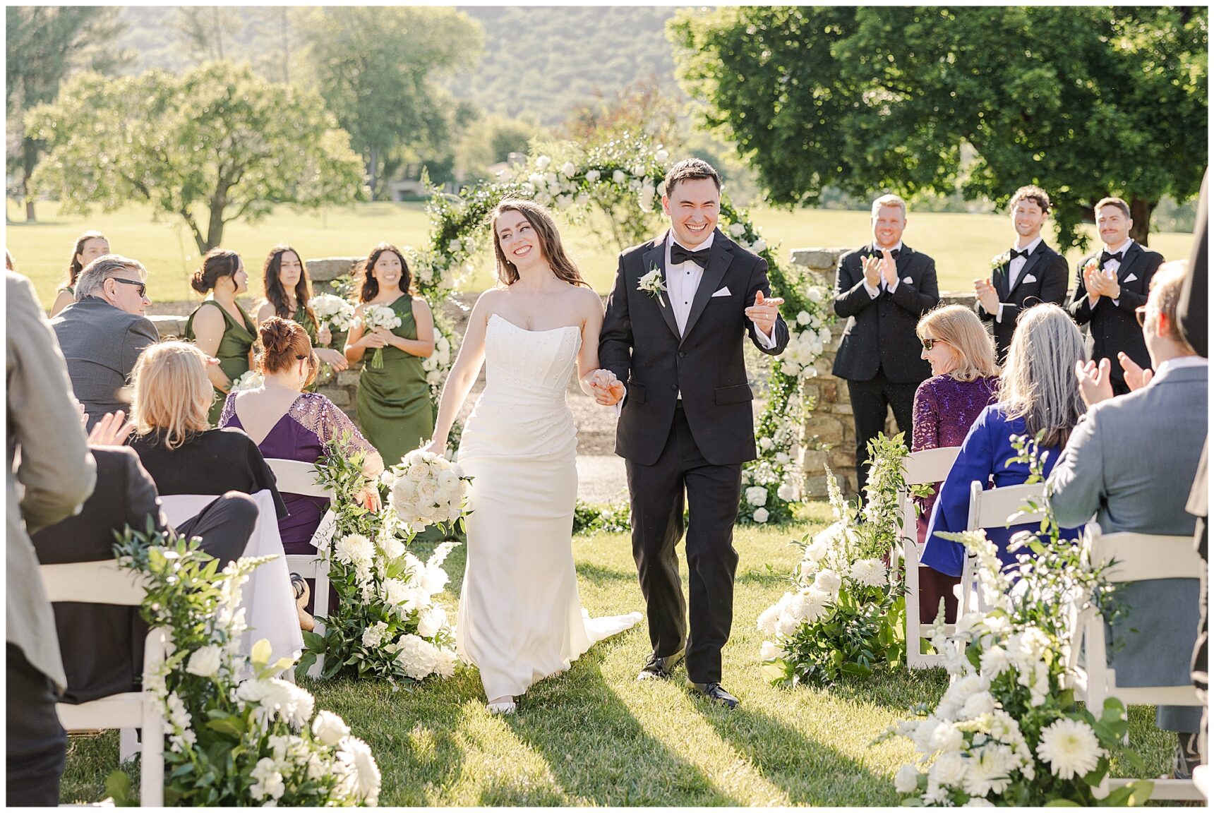 Bride and Groom walking down the aisle for their wedding recessional at Evergreen Country Club in Haymarket, Virginia.